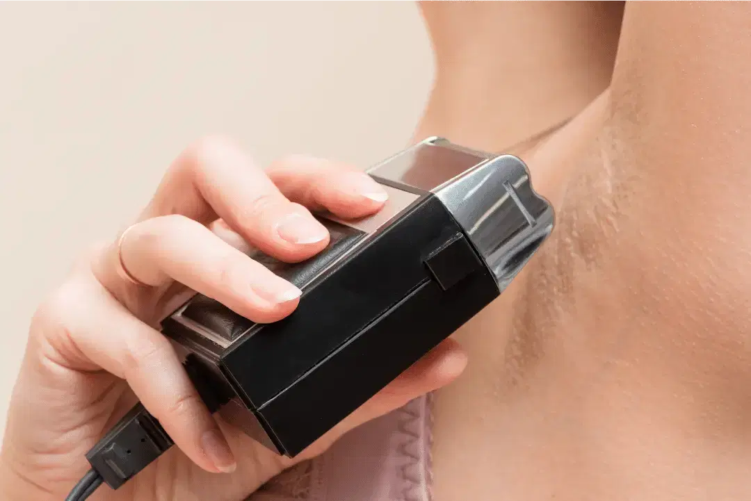 Side-by-side comparison of hair removal methods — razor, trimmer, depilatory cream, and IPL device on a bathroom counter