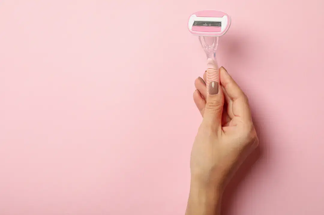 Pre-shave oil being applied to the skin to soften hair before a body shave