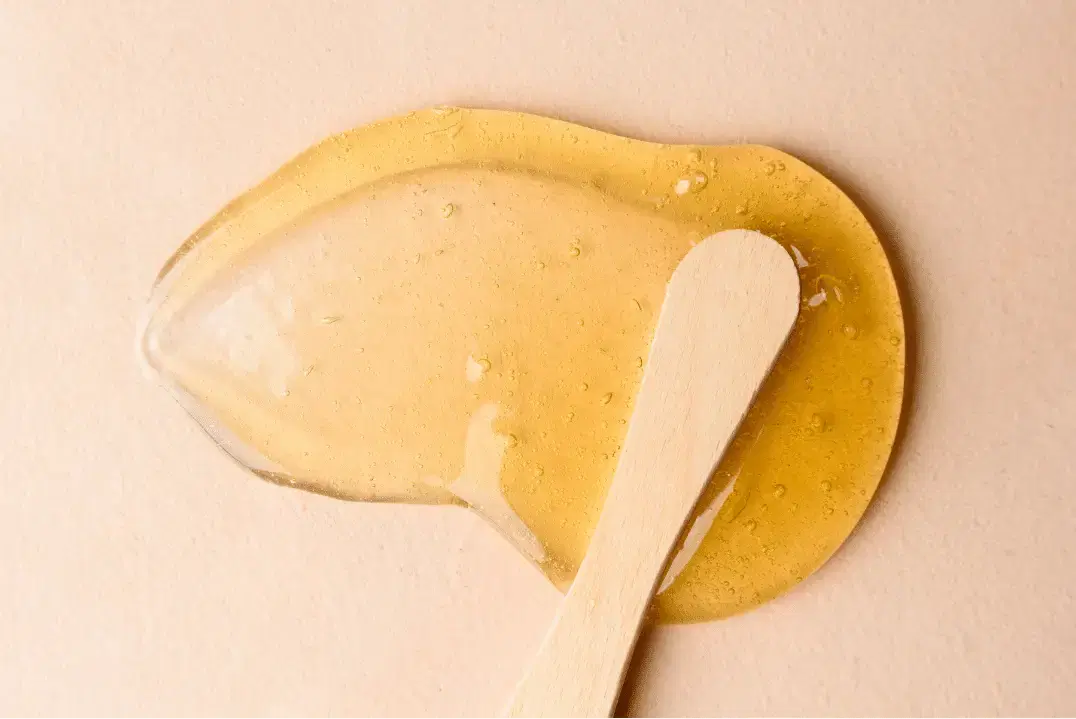 Waxing strip being applied to a leg for hair removal