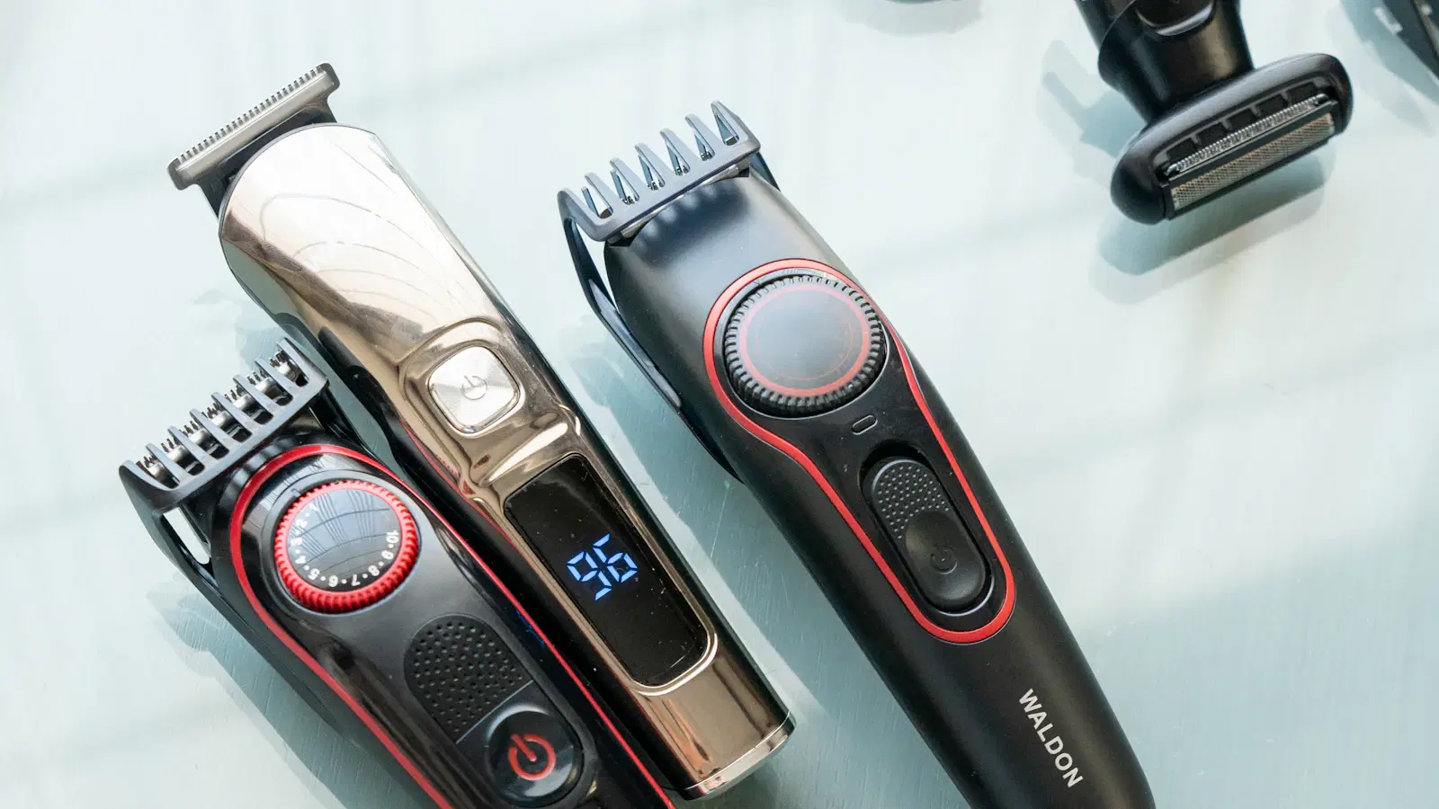 Body trimmer blade being oiled with a single drop of machine oil — routine maintenance that triples trimmer lifespan