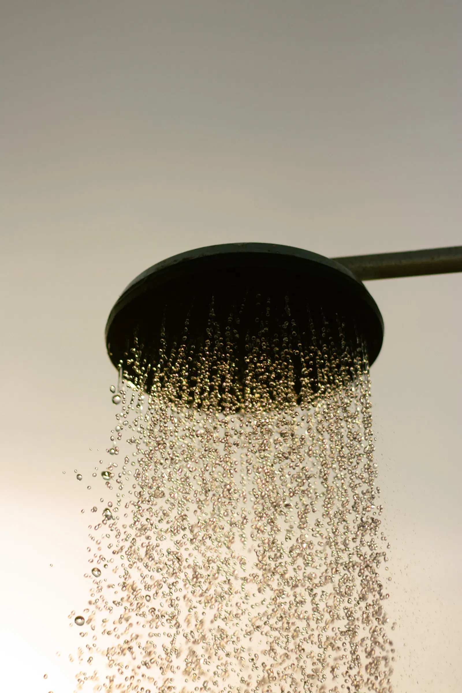 Water pouring from a round rain shower head