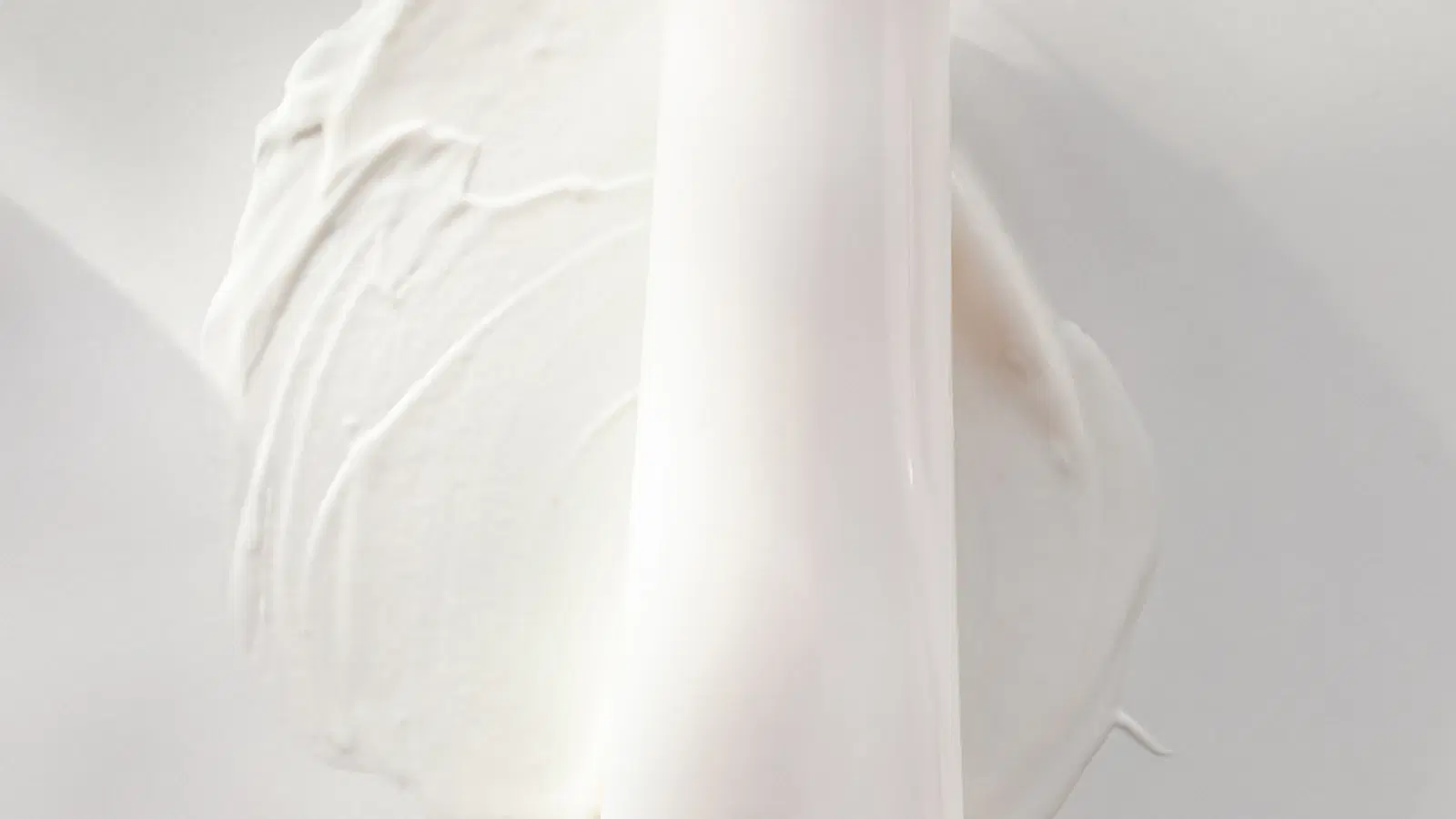 Depilatory cream applied to a femboy's forearm in an even layer — spatula spreading cream, timer set for seven minutes