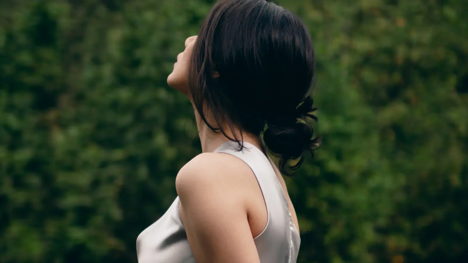 Minimal cute femboy makeup look — tinted BB cream, cream blush, lip gloss, and soft-groomed brows on a neutral background