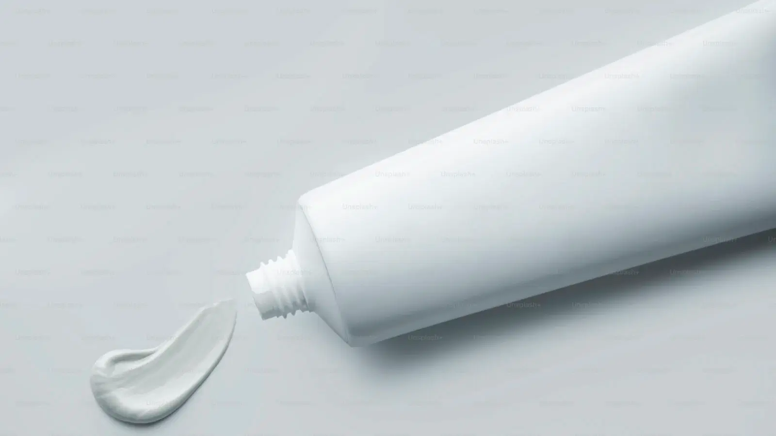 Shaving your butthole safely — mini bikini trimmer, hand mirror, and fragrance-free soothing spray arranged for a careful, slow grooming session