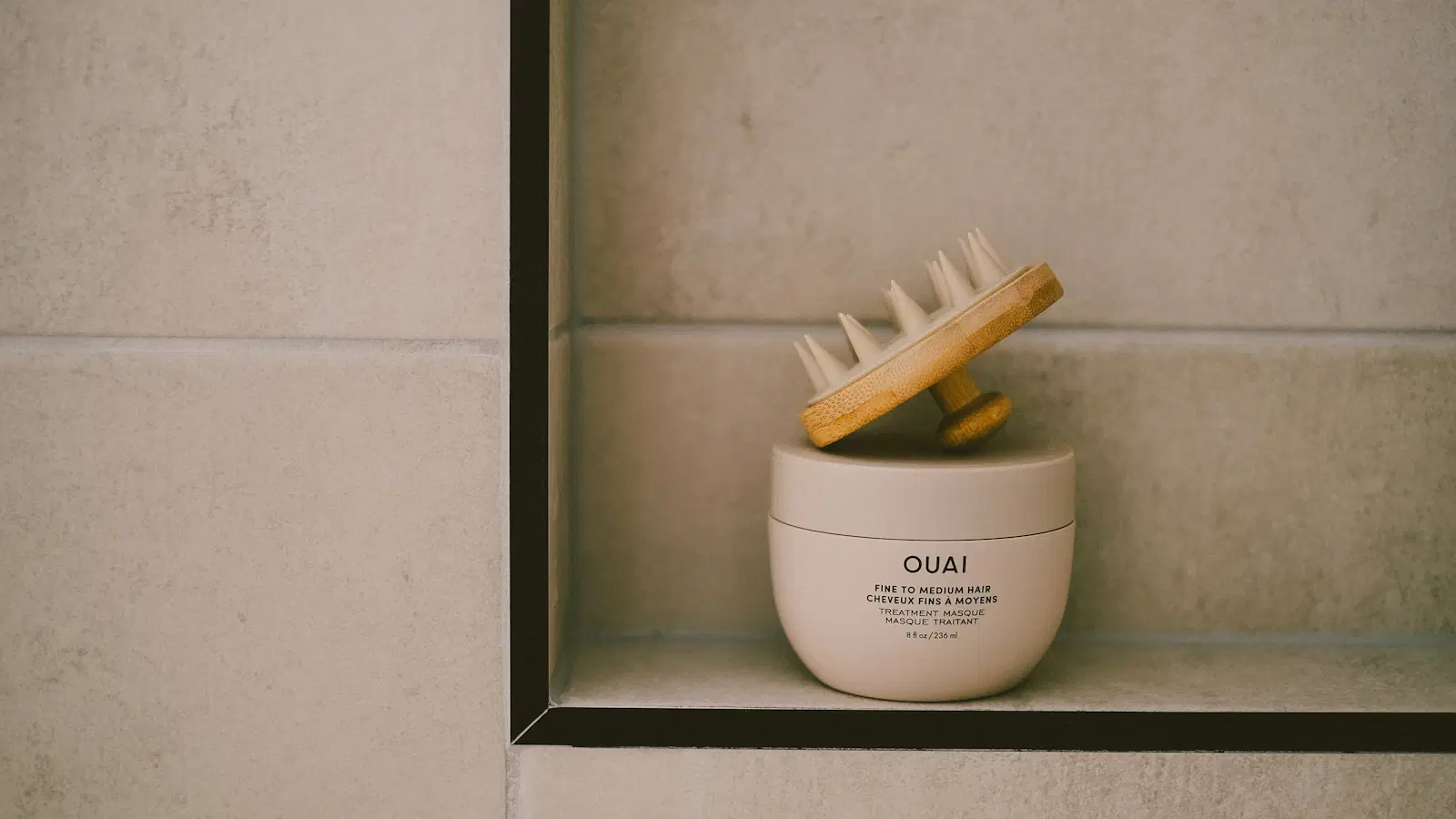 Golden sugar paste being kneaded by hand, showing the taffy-like consistency required for male sugaring to grab hair without sticking to skin