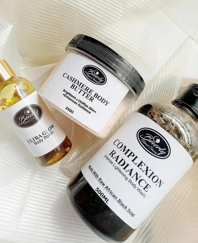 Flat-lay of post-shave skincare products — body butter, body polish, and aftercare balm